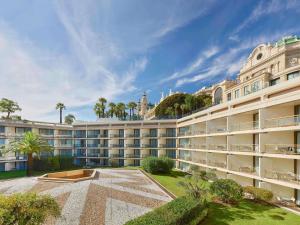 an exterior view of a large white building at Fairmont Monte Carlo in Monte Carlo +165 photos
