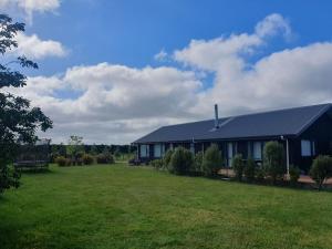 a house with a large yard in front of it at Homestead Hideaway in Ohoka in Ohoka
