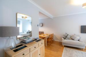 a living room with a mirror and a table at Stonehaven ground floor home with a spectacular harbour view. in Stonehaven