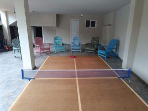 a room with chairs and a ping pong court at Hotel Kutaisi Globus in Kutaisi