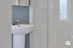 a bathroom with a white sink and a shower at Vacant Nests Seton Sands Kings Barns Starlink in Longniddry +21 photos