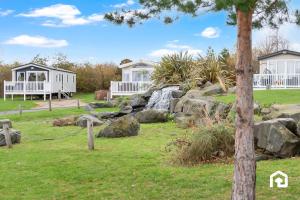 a garden with two houses and a waterfall at Vacant Nests Seton Sands Kings Barns Starlink in Longniddry