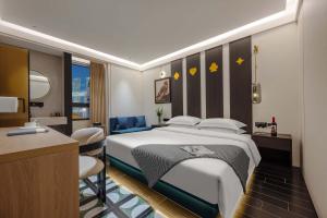 a hotel room with a bed and a desk at Chongqing INS·Wanbai Terrace River View Hotel (Jiefangbei Hongyadong Branch) in Nan'an