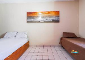 a bedroom with two beds and a picture on the wall at Condo 3, Easy Walk to San Felipe Malecon in San Felipe +24 photos