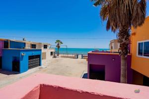 a view of the beach from a building with a palm tree at Condo 4, In town and steps to the beach and Malecon in San Felipe