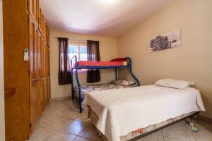a bedroom with two bunk beds and a window at Condo 4, In town and steps to the beach and Malecon in San Felipe +26 photos