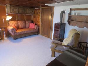 a living room with a couch and a chair at Biohof Langberg in Lauerz