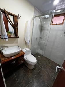a bathroom with a toilet and a shower at Villa Celeste in Macanal +33 photos