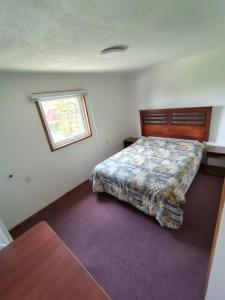 Ένα ή περισσότερα κρεβάτια σε δωμάτιο στο Hospedaje el Carmen