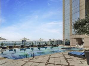 a swimming pool on the roof of a hotel at Fairmont Dubai in Dubai +182 photos