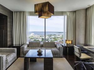 a living room with a couch and a table at Swissotel Tallinn in Tallinn