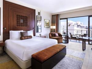 a bedroom with a large bed and a living room at Fairmont The Palm in Dubai