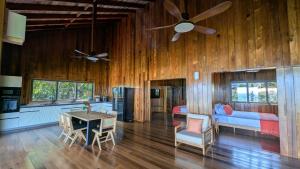 Woodford HillにあるTurtle Beach Hotel Calibishieの木製の壁のリビングルーム(天井ファン付)