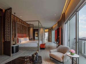 a hotel room with a bed and a balcony at Fairmont Singapore in Singapore