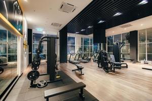 a gym with treadmills and cardio equipment in a building at Quill Residence by Infinity pool in Kuala Lumpur