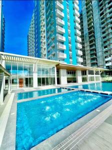 a swimming pool in front of a building at H4R1 Luxe Haven in Bacolod