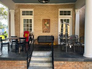 a patio with chairs and tables on a house at The Inn at Southern Oaks in Lavonia