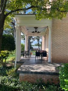 a pavilion with a table and chairs on a house at The Inn at Southern Oaks in Lavonia +16 photos