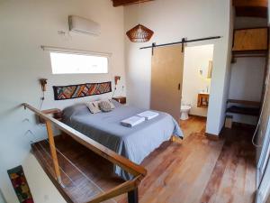 a small bedroom with a bed and a window at Malvón in Cafayate