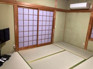 an empty room with a room with a window at 民泊絹家 in Izume