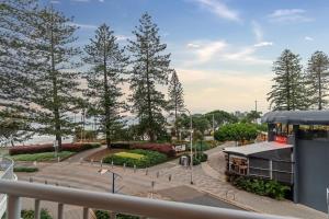 a view of a park with trees and a building at Brisbane Road Apartments Mooloolaba in Mooloolaba