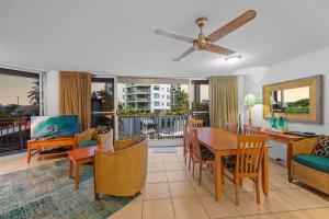 a living room with a dining room table and chairs at Brisbane Road Apartments Mooloolaba in Mooloolaba +25 photos