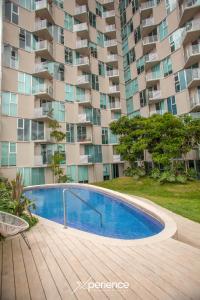 a swimming pool in front of a large apartment building at Firefly at 29, City Views and Wonderland Vibes! in Hatillo