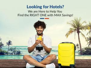 un hombre sentado en un banco con un teléfono amarillo y una maleta en HOTEL ARAWALI UDAIPUR CITY BEST couples friendly stay, en Udaipur