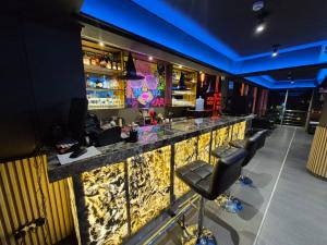 a bar with a stone counter and stools at Hotel Zaniah in Huancayo
