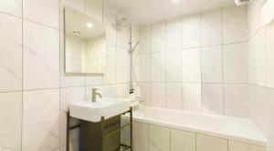 a white bathroom with a sink and a bath tub at browndot 서천 