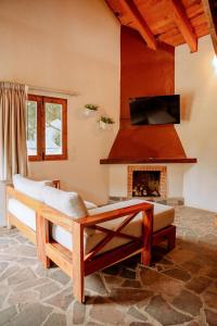 a living room with a couch and a fireplace at Hotel Puerta de Piedra in Tapalpa +18 photos