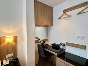 a small kitchen with a black counter top in a room at D Loft Hotel in Kuala Lumpur
