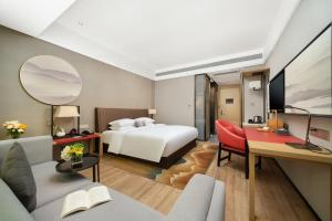 TV a/nebo společenská místnost v ubytování 南宁江南万达白沙大道怡程酒店