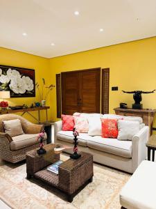 a living room with two couches and a table at Casa Acantilado Oslob - 3BR in Oslob