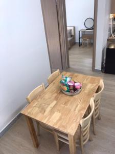 a wooden table with chairs and a bowl on it at Simple House-Simple Life in Long Xuyên