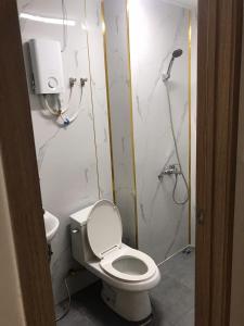 a bathroom with a toilet and a shower at Simple House-Simple Life in Long Xuyên