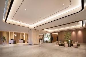 a lobby of a hotel with couches and tables at Hilton Garden Inn Lanzhou Anning in Lanzhou