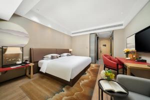 Postel nebo postele na pokoji v ubytování 南宁江南万达白沙大道怡程酒店