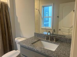 a bathroom with a sink and a toilet at The Magnolia Suite in Oxford