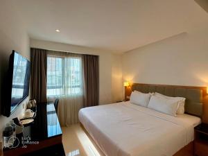 a hotel room with a bed and a television at D Loft Hotel in Kuala Lumpur