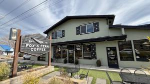 a fox and firm coffee sign in front of a building at Bluebird Day - Fox Den South in Bend