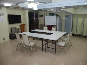 a conference room with a white table and chairs at Hotel Tateshina in Tokyo
