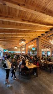 a group of people sitting at tables in a restaurant at Hotel Puerta de Piedra in Tapalpa