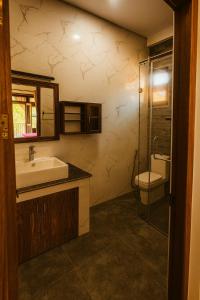 a bathroom with a sink and a toilet at Pearl Paradise Villa in Aluthgama +48 photos