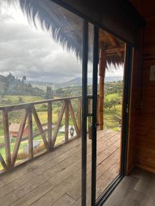 a room with a balcony with a view at El Dorado Refugio Muisca in Guatavita +22 photos