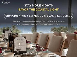 a restaurant with a long table with chairs and glasses at Wyndham Soleil Danang - Free Two ways Airport Transport in Da Nang