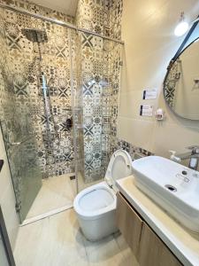 a bathroom with a shower and a toilet and a sink at DreamHome - Starry in Ho Chi Minh City