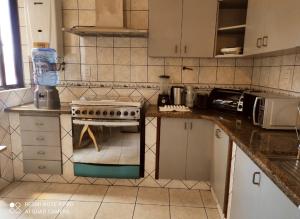 a kitchen with a stove and a microwave at Departamentos de Altura in Tarija +9 photos