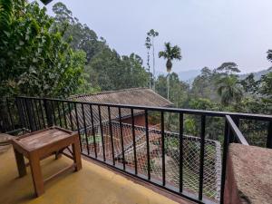 a balcony with a bench and a view of the mountains at New Green View Guest House Kithal Ella in Badulla