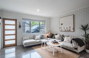 a living room with a couch and a table at Relax Inn in Mulwala